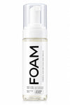 A clear bottle of FOAM cleansing foam with a white pump dispenser and a white label featuring bold black text, set against a plain white background.